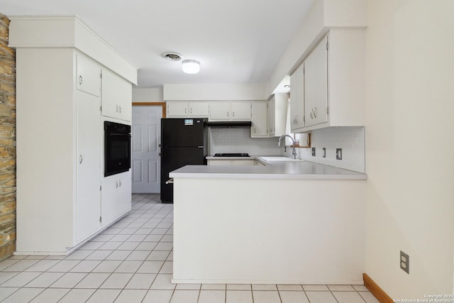 4722 Hollyridge, San Antonio, TX 78228 - kitchen featuring black appliances, decorative backsplash, a peninsula, under cabinet range hood, and light countertops