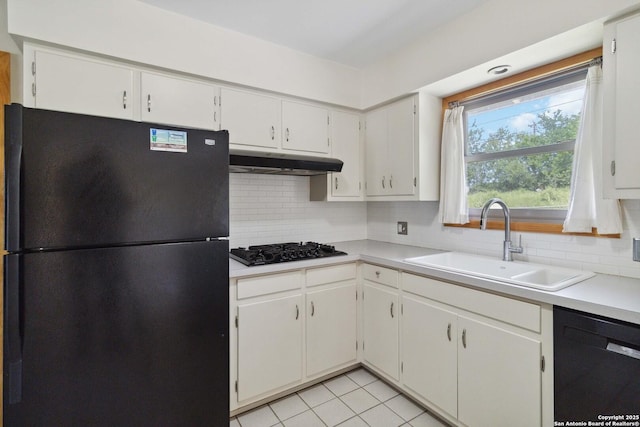 4722 Hollyridge, San Antonio, TX 78228 - kitchen with black appliances, under cabinet range hood, tasteful backsplash, and light countertops