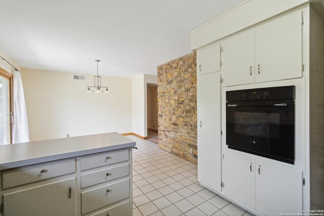4722 Hollyridge, San Antonio, TX 78228 - kitchen featuring black oven, light tile patterned flooring, pendant lighting, and light countertops