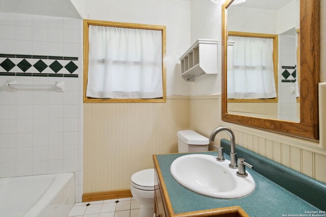 4722 Hollyridge, San Antonio, TX 78228 - bathroom with tile patterned flooring, vanity, and wainscoting