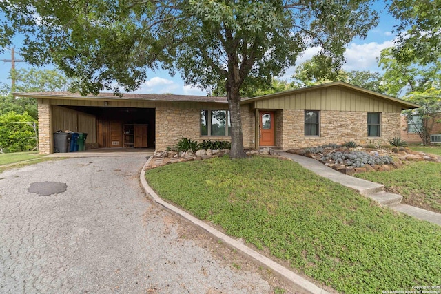 4722 Hollyridge, San Antonio, TX 78228 - single story home with asphalt driveway, stone siding, and a front lawn