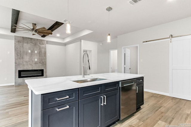 9911 Loma Alta Cir, Converse, TX 78109 - kitchen with stainless steel dishwasher, ceiling fan, a barn door, light wood-style floors, and recessed lighting