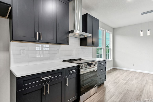 9911 Loma Alta Cir, Converse, TX 78109 - kitchen featuring stainless steel electric stove, wall chimney exhaust hood, decorative backsplash, light wood-style floors, and light countertops