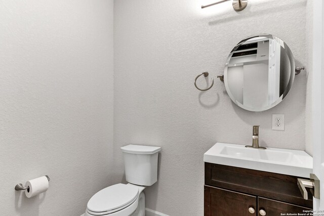 9911 Loma Alta Cir, Converse, TX 78109 - half bathroom featuring toilet and vanity