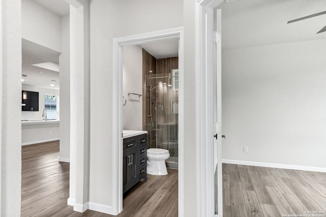 9911 Loma Alta Cir, Converse, TX 78109 - full bathroom with vanity, a stall shower, wood finished floors, and ceiling fan