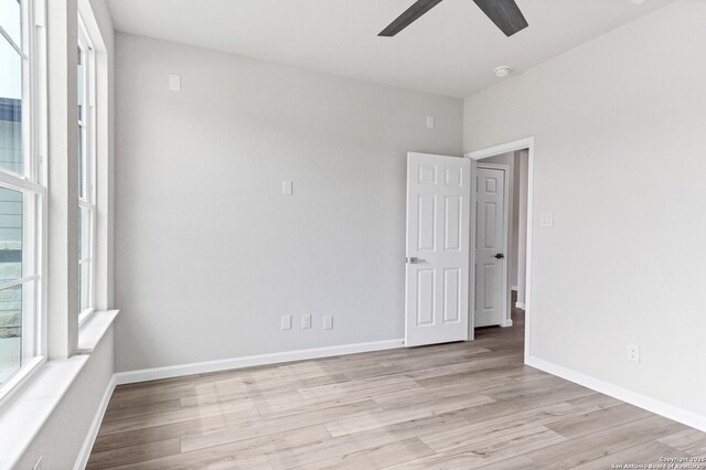 9911 Loma Alta Cir, Converse, TX 78109 - empty room with ceiling fan, light wood finished floors, and a smoke detector