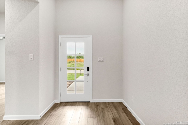 9911 Loma Alta Cir, Converse, TX 78109 - doorway to outside with wood finished floors and a textured wall