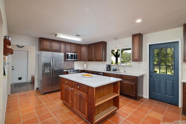 10567 Rocking M, Helotes, TX 78023 - kitchen featuring appliances with stainless steel finishes, decorative backsplash, light countertops, light tile patterned floors, and recessed lighting