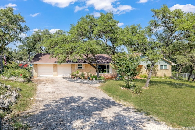 10567 Rocking M, Helotes, TX 78023 - view of front of home featuring brick siding, driveway, and an attached garage