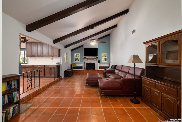 10567 Rocking M, Helotes, TX 78023 - tiled living area with beam ceiling, ceiling fan, a brick fireplace, and high vaulted ceiling