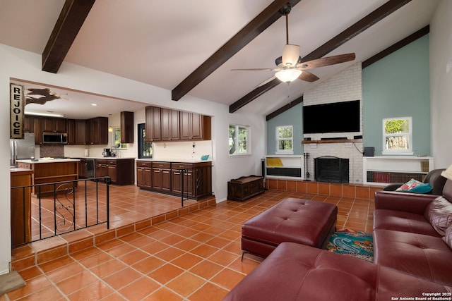 10567 Rocking M, Helotes, TX 78023 - living area with beamed ceiling, light tile patterned floors, ceiling fan, a brick fireplace, and high vaulted ceiling