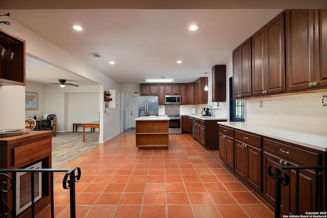 10567 Rocking M, Helotes, TX 78023 - kitchen with appliances with stainless steel finishes, decorative backsplash, light countertops, recessed lighting, and a ceiling fan