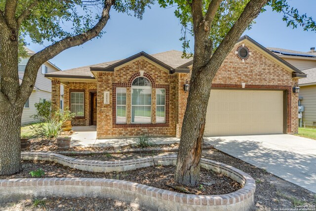 26215 Presidio Blf, Boerne, TX 78015 - view of front facade featuring brick siding, an attached garage, driveway, and roof with shingles