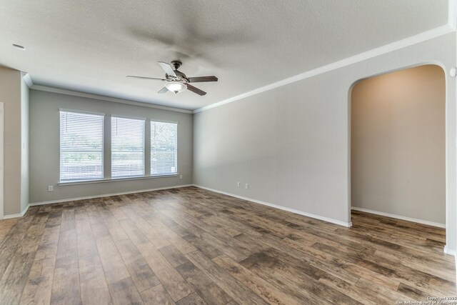 26215 Presidio Blf, Boerne, TX 78015 - empty room featuring arched walkways, ceiling fan, ornamental molding, a textured ceiling, and wood finished floors