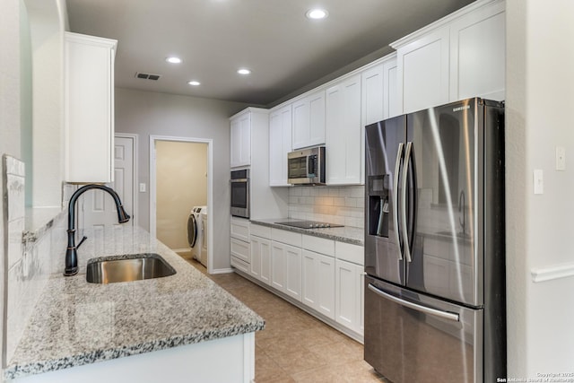 26215 Presidio Blf, Boerne, TX 78015 - kitchen with appliances with stainless steel finishes, tasteful backsplash, recessed lighting, white cabinets, and light stone counters