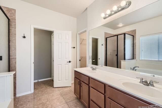 26215 Presidio Blf, Boerne, TX 78015 - full bathroom with a stall shower, a walk in closet, a bath, double vanity, and tile patterned floors