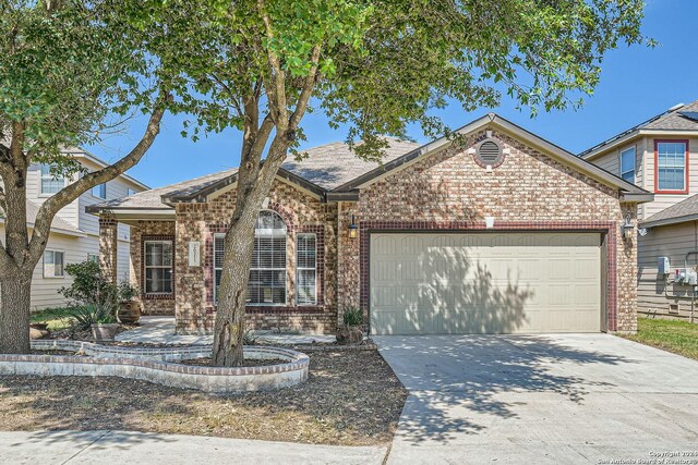26215 Presidio Blf, Boerne, TX 78015 - view of front of home featuring brick siding, a garage, and driveway