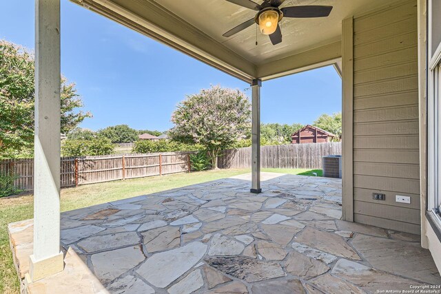 26215 Presidio Blf, Boerne, TX 78015 - fenced backyard with ceiling fan and a patio