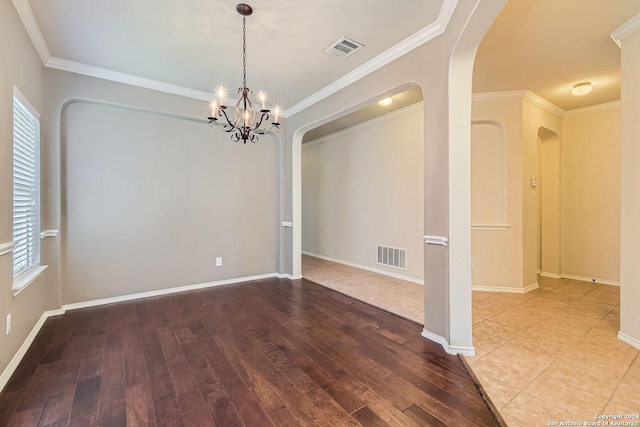 26215 Presidio Blf, Boerne, TX 78015 - empty room featuring arched walkways, wood-type flooring, a chandelier, and ornamental molding