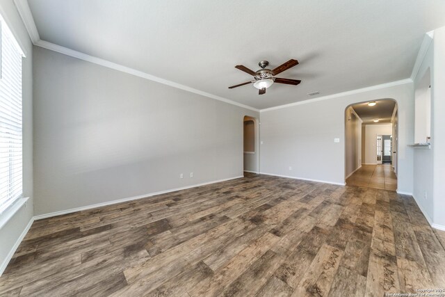 26215 Presidio Blf, Boerne, TX 78015 - empty room featuring arched walkways, ceiling fan, plenty of natural light, and crown molding