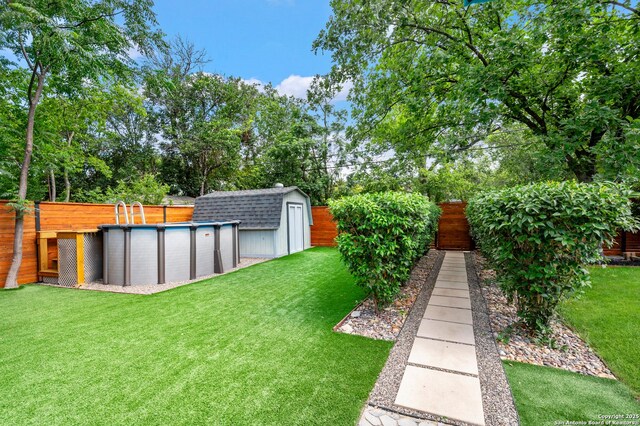 227 Devonshire, San Antonio, TX 78209 - fenced backyard with a storage shed, an outdoor pool, and view of wooded area