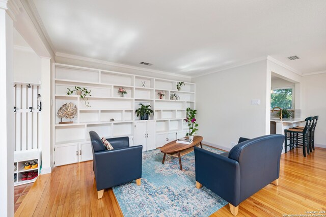 227 Devonshire, San Antonio, TX 78209 - living room with light wood finished floors and crown molding