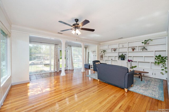 227 Devonshire, San Antonio, TX 78209 - living area featuring ornamental molding, wood finished floors, a ceiling fan, healthy amount of natural light, and decorative columns