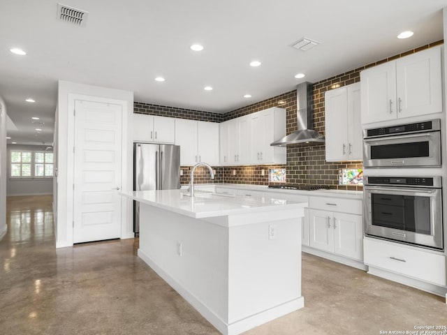 338 E Olmos, San Antonio, TX 78212 - kitchen with wall chimney range hood, concrete floors, appliances with stainless steel finishes, recessed lighting, and white cabinetry