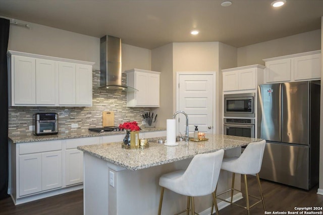 12904 Liam Ct, Saint Hedwig, TX 78152 - kitchen with stainless steel appliances, wall chimney exhaust hood, white cabinetry, tasteful backsplash, and recessed lighting