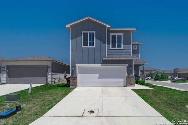 12904 Liam Ct, Saint Hedwig, TX 78152 - view of front of property with board and batten siding, brick siding, driveway, and a front yard