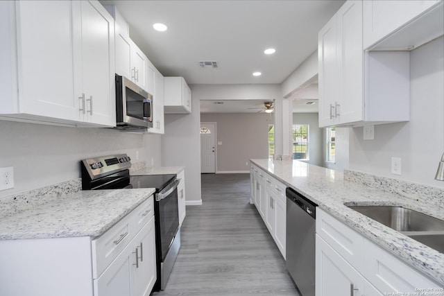 2738 Ravina, San Antonio, TX 78222 - kitchen with appliances with stainless steel finishes, recessed lighting, ceiling fan, and white cabinetry