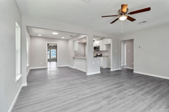 2738 Ravina, San Antonio, TX 78222 - unfurnished living room with a ceiling fan and wood finished floors