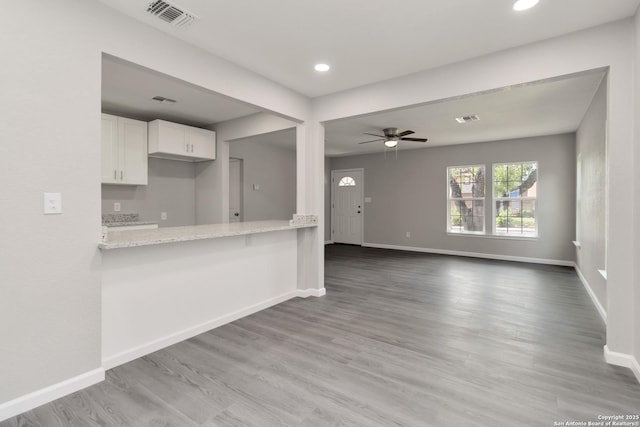 2738 Ravina, San Antonio, TX 78222 - kitchen featuring white cabinetry, wood finished floors, light stone countertops, recessed lighting, and a ceiling fan