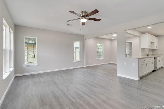 2738 Ravina, San Antonio, TX 78222 - unfurnished living room featuring light wood-type flooring, a ceiling fan, and recessed lighting
