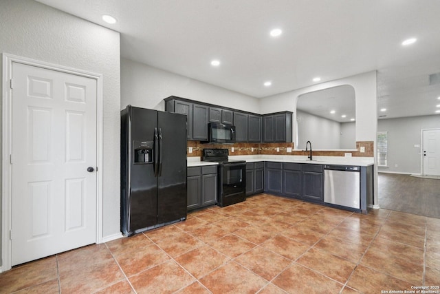 12107 Dawson Cir, San Antonio, TX 78253 - kitchen featuring black appliances, light countertops, arched walkways, recessed lighting, and backsplash