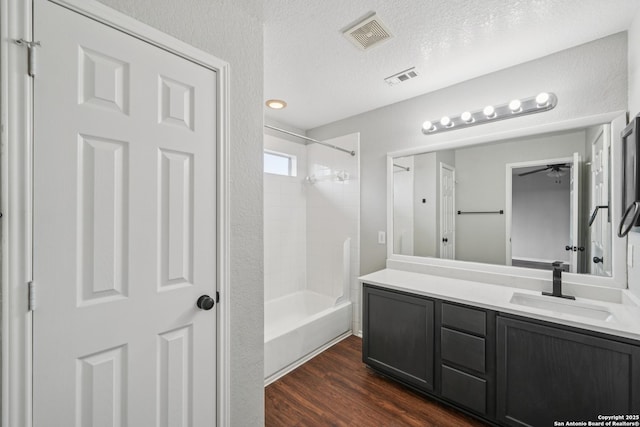 12107 Dawson Cir, San Antonio, TX 78253 - full bathroom featuring vanity, tub / shower combination, wood finished floors, a ceiling fan, and a textured ceiling