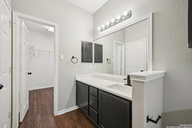 12107 Dawson Cir, San Antonio, TX 78253 - bathroom featuring wood finished floors, a textured wall, vanity, and a spacious closet