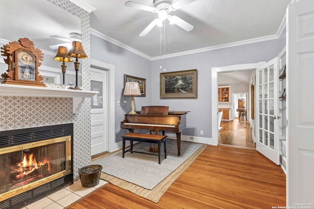 2 Fm 289, Comfort, TX 78013 - living area featuring a ceiling fan, wood finished floors, ornamental molding, a fireplace, and french doors