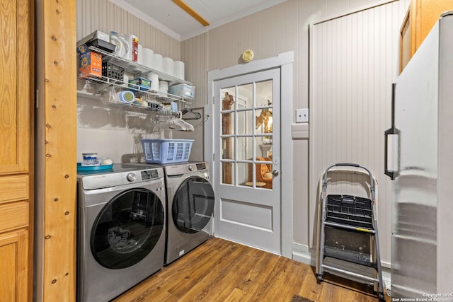 2 Fm 289, Comfort, TX 78013 - laundry room featuring washer and dryer, ornamental molding, and wood finished floors