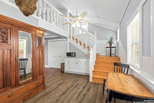2 Fm 289, Comfort, TX 78013 - dining space featuring stairs, dark wood-style floors, a ceiling fan, and a wainscoted wall