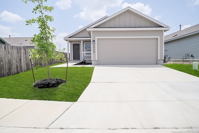 7002 Satellite, San Antonio, TX 78252 - view of front facade with driveway, an attached garage, and board and batten siding