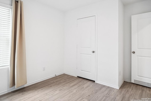 7002 Satellite, San Antonio, TX 78252 - unfurnished bedroom featuring light wood-style flooring