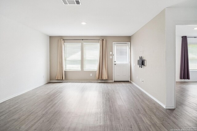 7002 Satellite, San Antonio, TX 78252 - unfurnished living room with wood finished floors and baseboards