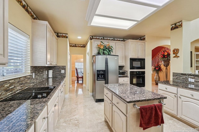 1810 Three Frks, San Antonio, TX 78258 - kitchen with black appliances, arched walkways, tasteful backsplash, and dark stone countertops