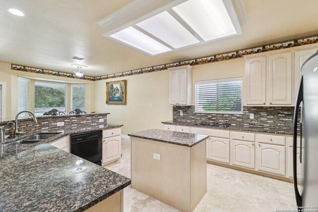 1810 Three Frks, San Antonio, TX 78258 - kitchen with black appliances, a kitchen island, plenty of natural light, and tasteful backsplash