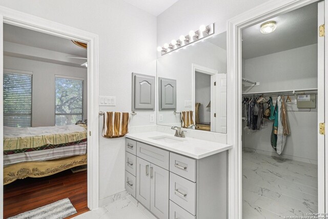 1810 Three Frks, San Antonio, TX 78258 - full bathroom with marble finish flooring, vanity, a spacious closet, and connected bathroom