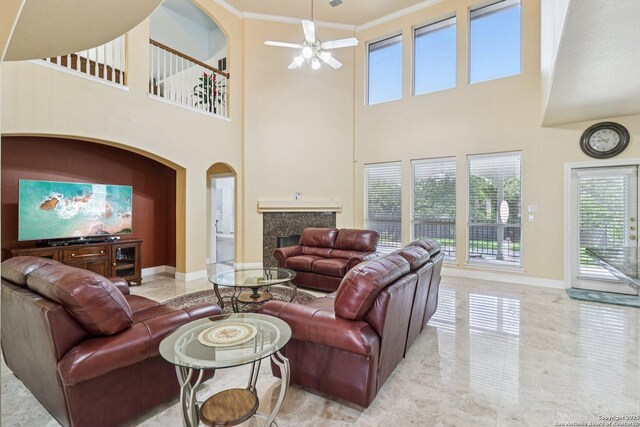 1810 Three Frks, San Antonio, TX 78258 - living room featuring a premium fireplace, crown molding, a towering ceiling, and a ceiling fan