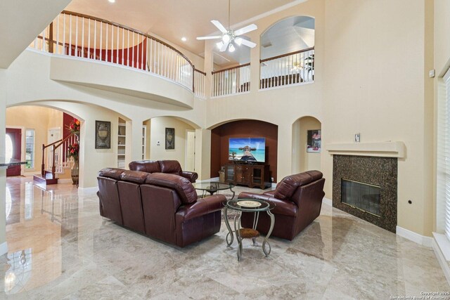 1810 Three Frks, San Antonio, TX 78258 - living room with marble tiled flooring, a ceiling fan, a high end fireplace, a high ceiling, and built in shelves