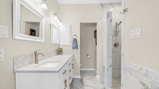 21810 Thunder Basin, San Antonio, TX 78261 - bathroom with double vanity, marble look tiles, and a marble finish shower