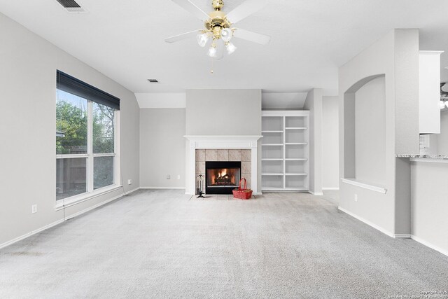4481 Owl Crk, Schertz, TX 78154 - unfurnished living room with carpet, ceiling fan, and a tile fireplace